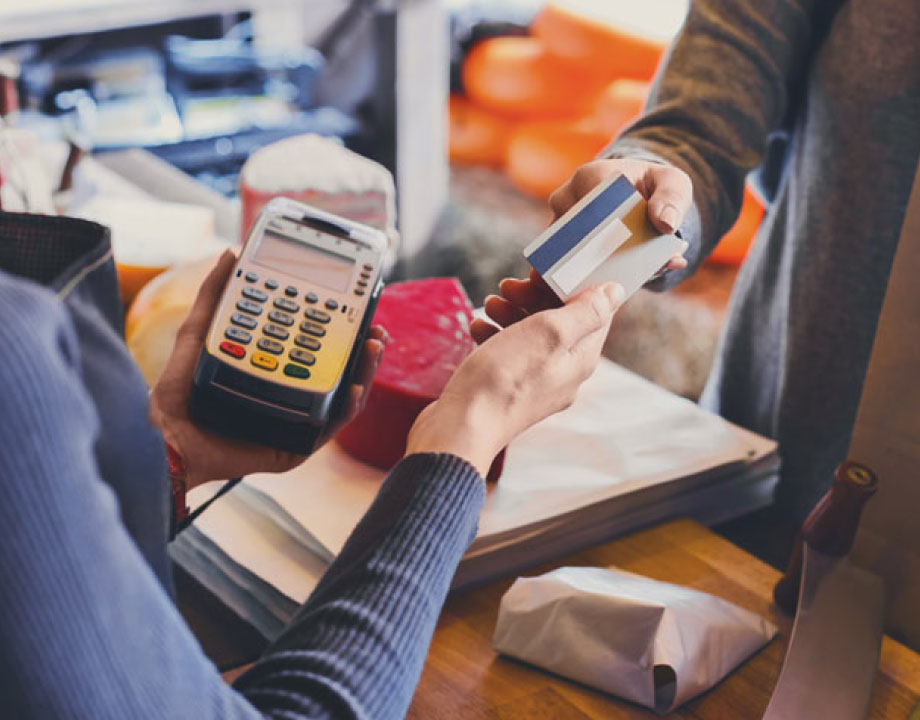 woman hands card back to customer